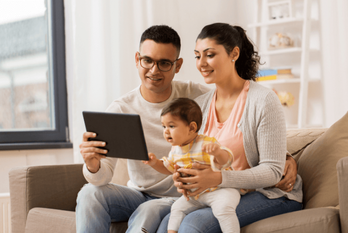 mother and father participating in an online parent group with their child